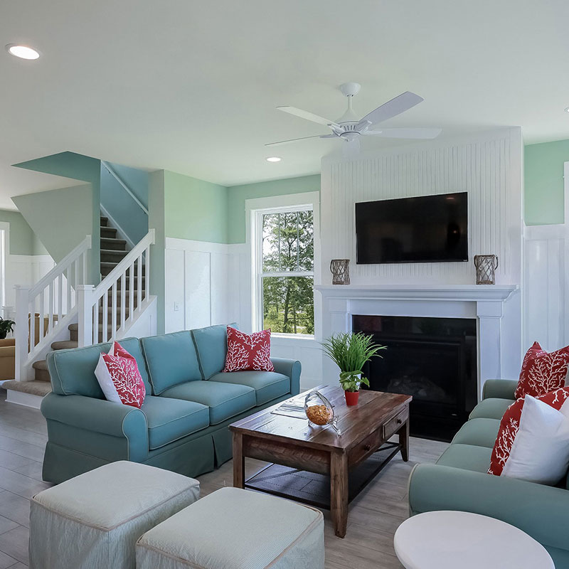 A living room with couches, chairs and a television.