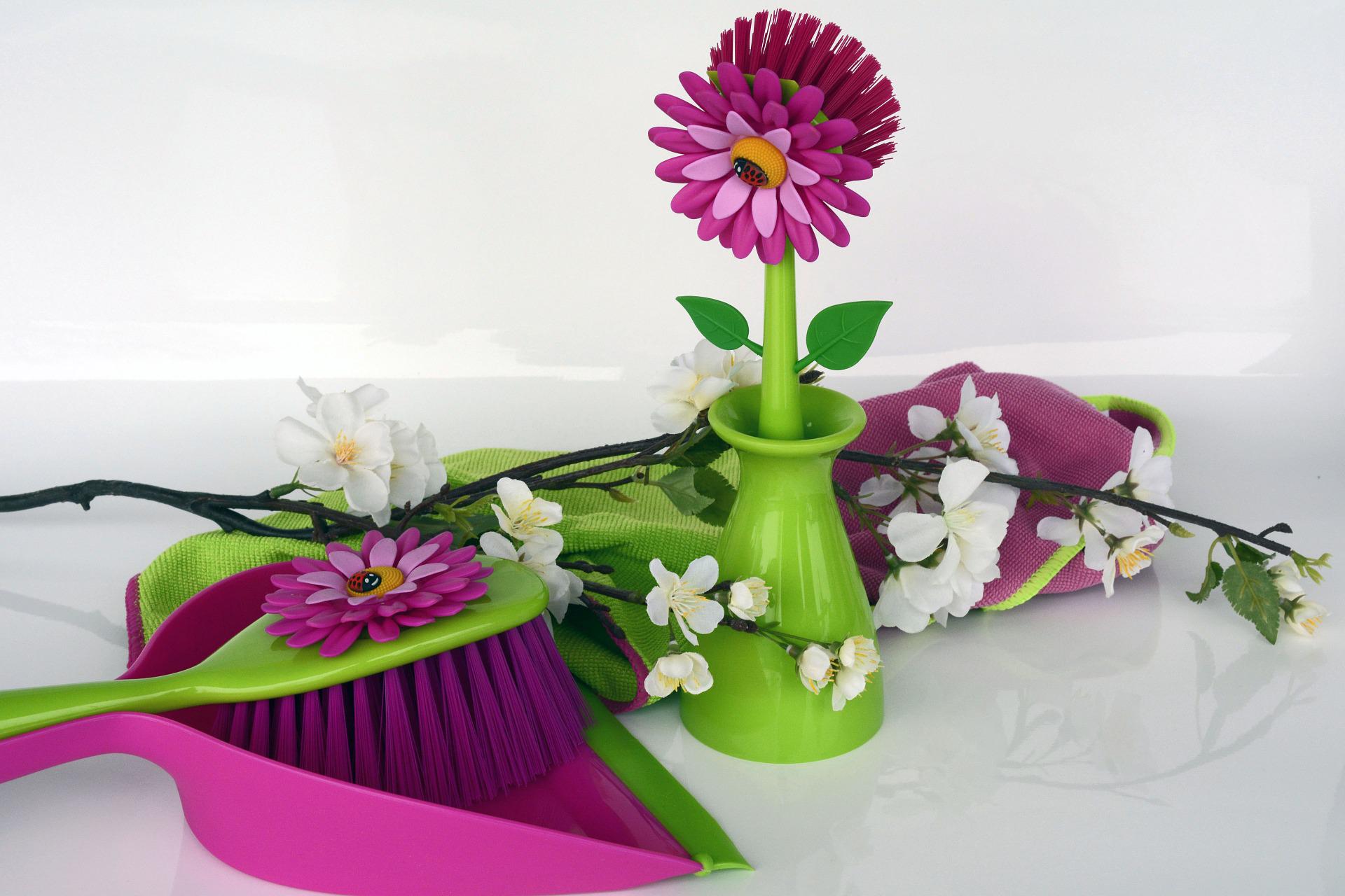 A green vase with flowers on top of it.