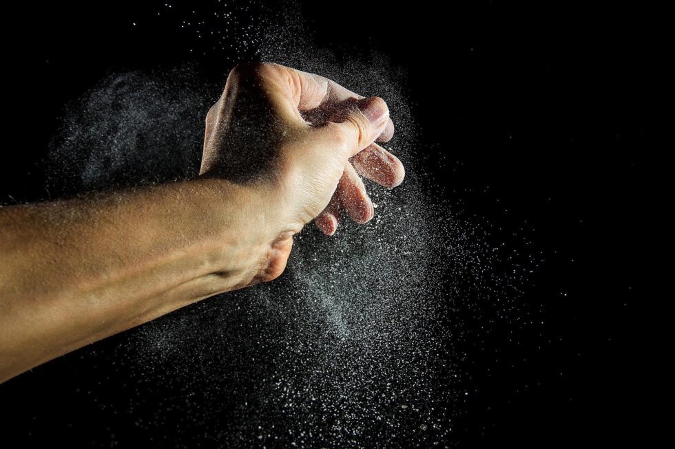 A person is holding their hands out in the dark.