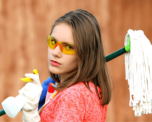 A woman holding a mop and wearing sunglasses.