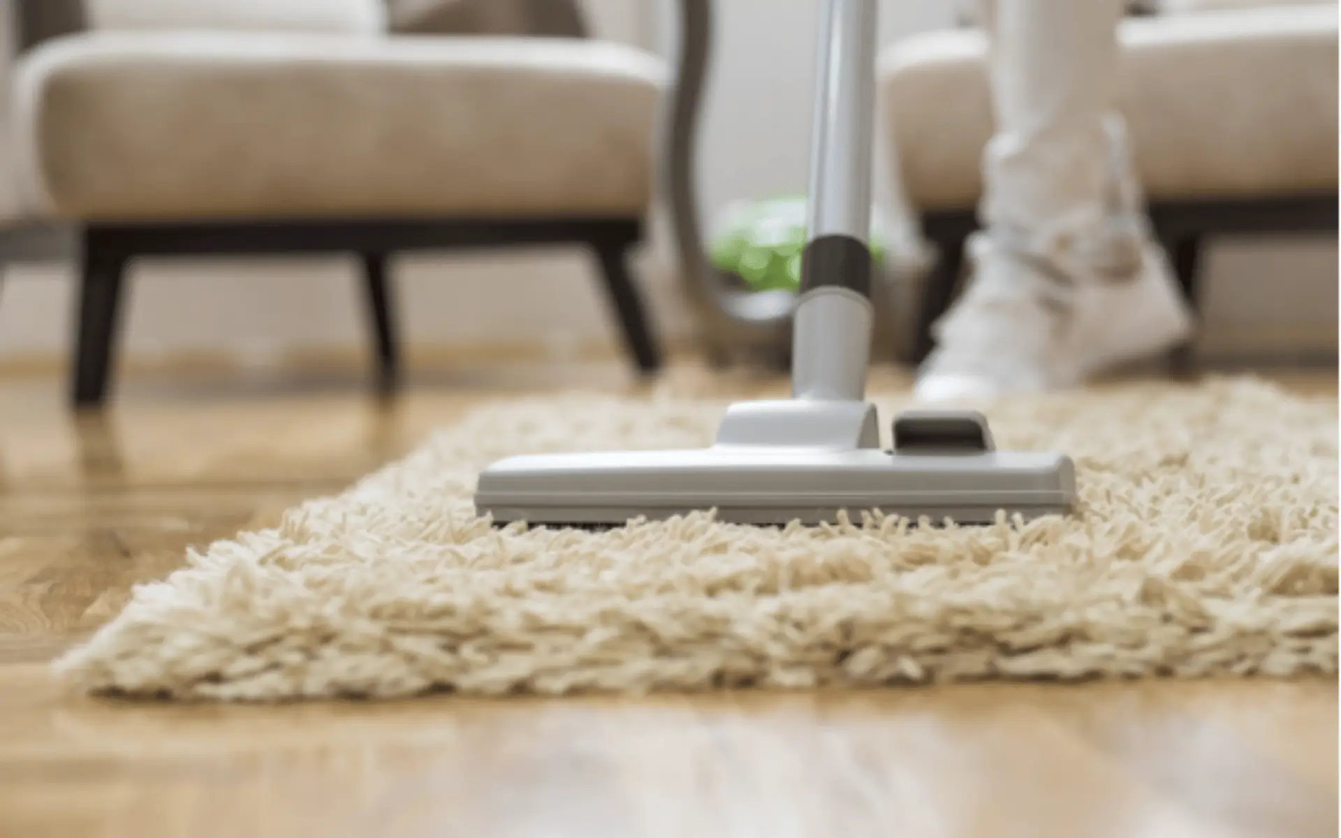 A person using a vacuum on the floor