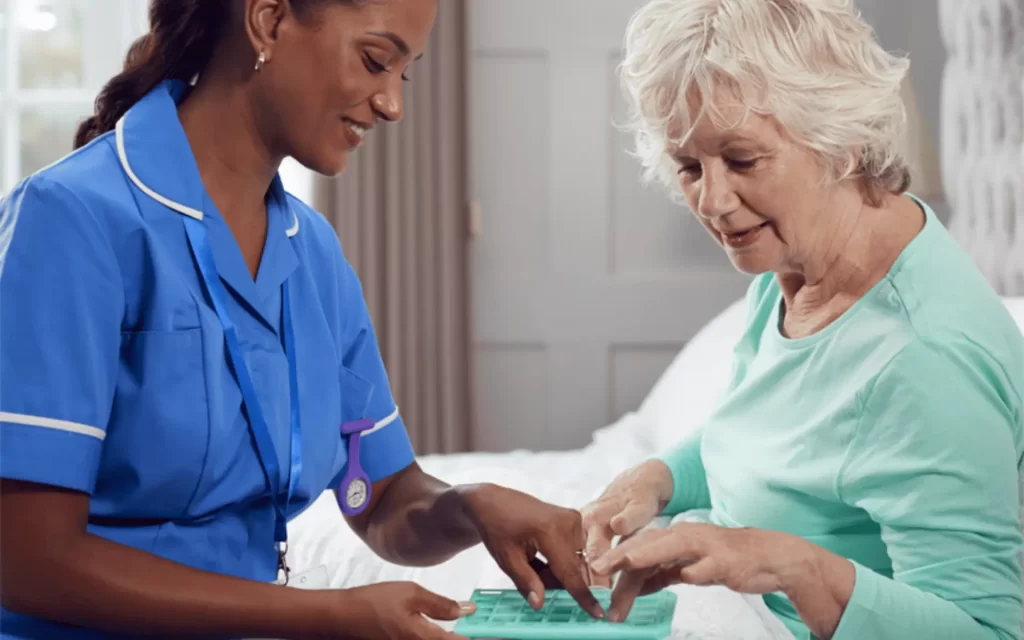 A nurse and an elderly woman are working together.