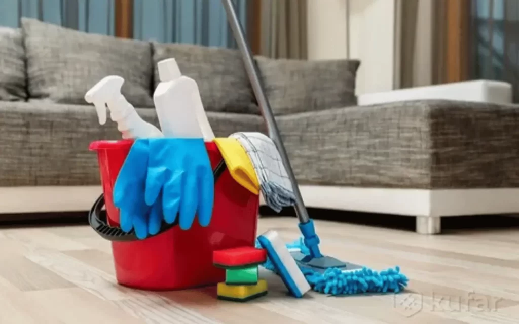 A bucket of cleaning supplies sitting on the floor.