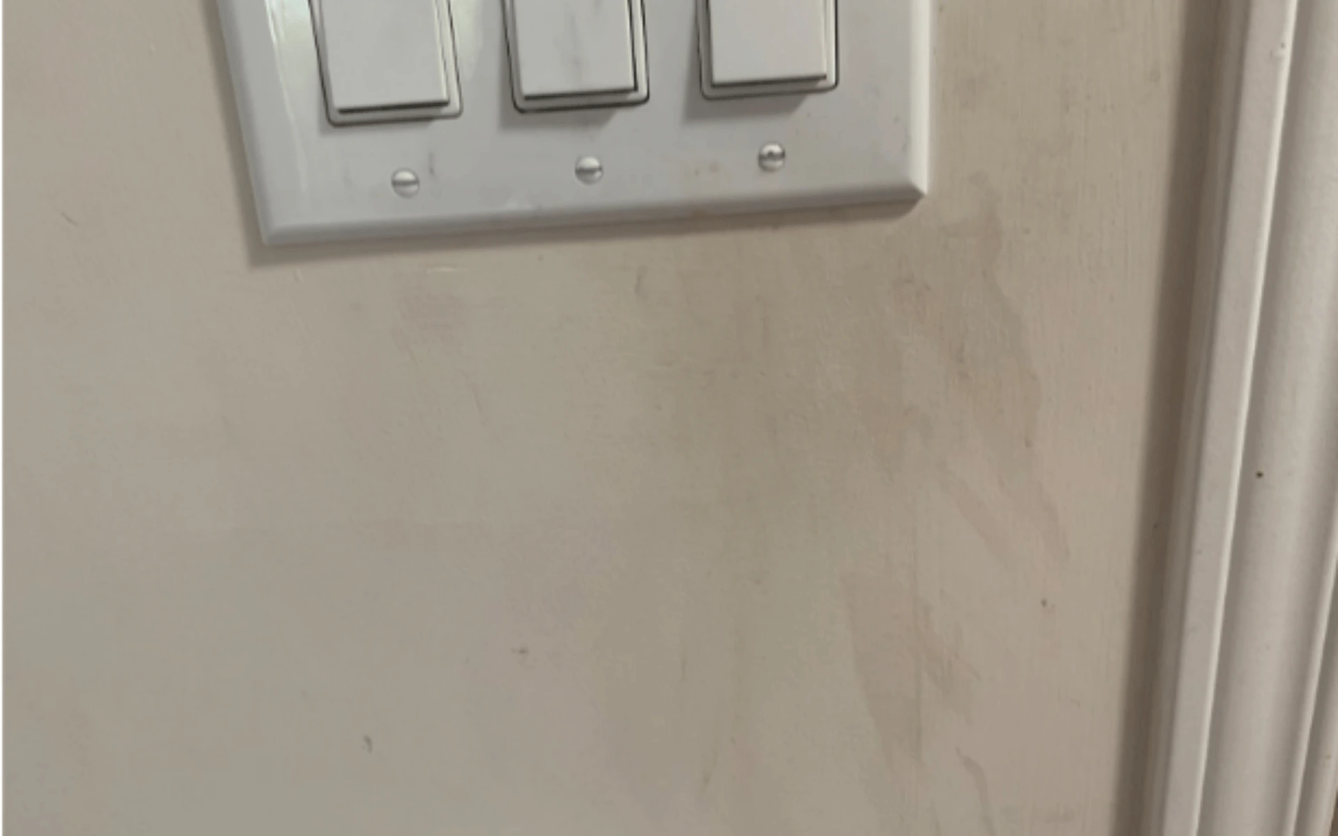 A white light switch on the wall