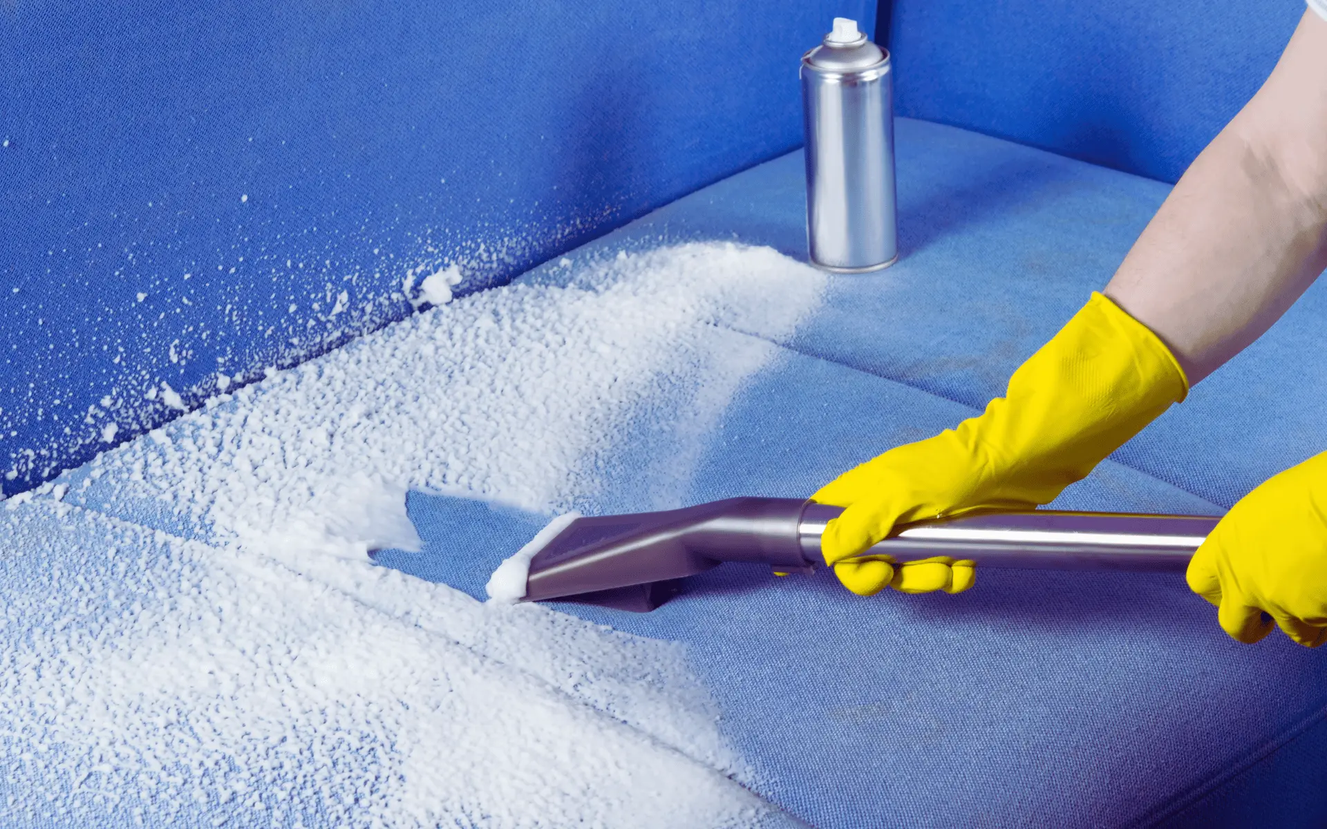 A person in yellow gloves cleaning the floor.